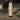 Decorative outdoor lamp with wicker design on a stone patio