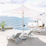 Grand Patio 11 ft sunshade umbrella with a white canopy, positioned near lounge chairs by the ocean.