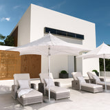 Grand Patio 11 ft sunshade umbrella with a pulley lift, positioned near lounge chairs by a modern poolside setting.