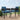Grandpatio steel outdoor dining side chairs with grey cushions, set on a wooden deck against a scenic backdrop.
