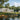 Modern house by a lake with people kayaking and relaxing