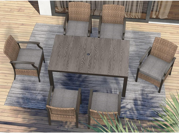 Traditional wicker patio dining set with six chairs and a rectangular table on a wooden deck.