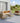 Outdoor patio furniture set with beige cushions on a wooden deck.