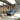 Grand Patio outdoor wicker sectional sofa with thick blue cushions, set in a modern patio environment.