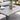Outdoor table with a cup, saucer, and vase on a patio setting