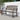 Grand Patio outdoor bench with a faux wood finish, featuring a slatted design and armrests, set against a white wall.