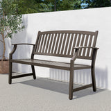 Grand Patio outdoor bench with a faux wood finish, featuring a slatted design and armrests, set against a white wall.