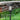 Solar garden light in rain with text 'Weather Resistant' on grass and brick wall background