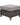 Wicker ottoman with a gray cushion on a white background