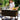 Woman preparing food on a portable outdoor kitchen in a garden setting