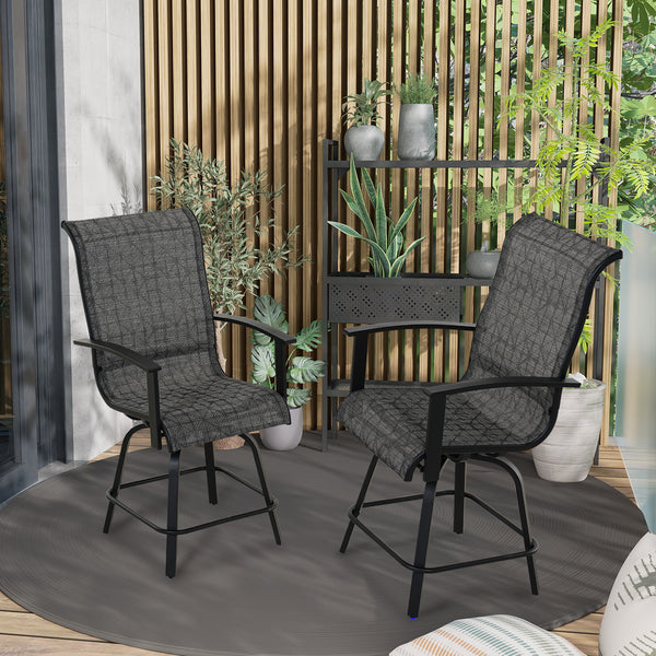 Two black outdoor chairs on a patio with plants and a wooden screen in the background.