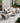 Outdoor patio furniture set with chairs and a table on a stone patio.
