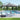 Outdoor patio umbrella with striped canopy over lounge chairs by a pool