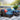 Outdoor patio furniture set with blue cushions and a pool in the background
