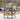 Wicker bar cart with drinks and glasses on a patio