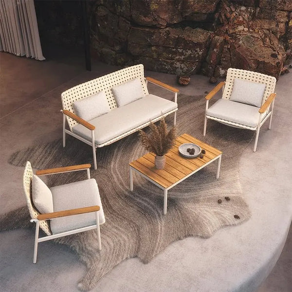 Outdoor furniture set with a wooden table on a stone patio.