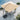 Beige patio umbrella with a motorized base on a patio with chairs and a pool in the background.