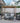 Outdoor patio with gray furniture, pergola, and plants