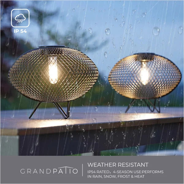 Two weather-resistant outdoor lights on a deck with raindrops on the glass.
