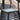 Black woven stool with a glass top on a reflective surface