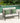 Outdoor sofa with green cushions by a poolside