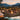 Outdoor gathering around a fire pit with mountains in the background