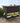 Wicker bar cart on a wooden deck with outdoor setting
