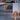 Wooden outdoor lanterns on a patio with a modern architectural background