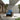 Grand Patio outdoor wicker sectional sofa with thick blue cushions and a steel frame, set in a modern patio environment.