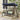 Wooden swing with blue canopy and green and white cushion on a patio.