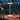 Table lamp on a dining table with a blurred background of people and lights