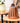 Brown woven lantern on a wooden table with a blurred indoor background