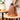 Brown woven lantern on a wooden table with a blurred indoor background