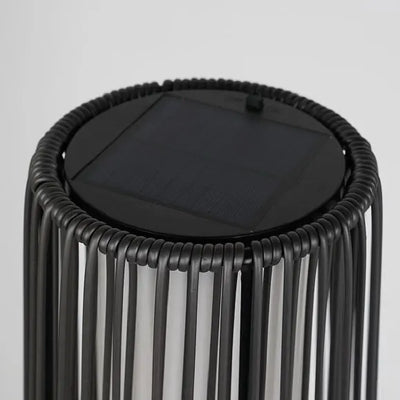 Black woven stool with a solar panel on a gray background