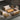 Outdoor patio furniture set with fire pit table on a concrete floor.