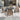 Grand Patio outdoor dining set featuring a square table and four wicker chairs with gray cushions on a patio.