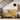 Yellow garden bench with floral lattice design, two pillows, and a plant beside a staircase and wall hooks.