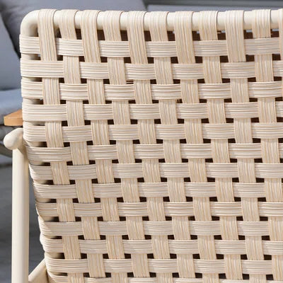 Close-up of a woven chair seat with a geometric pattern.