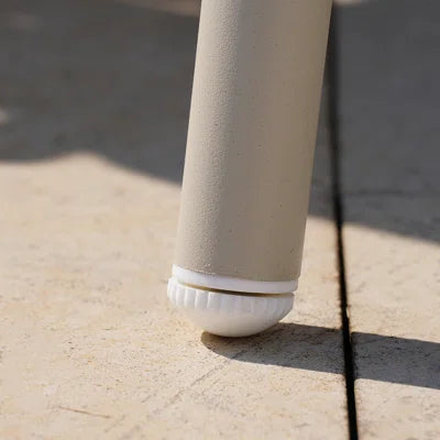 Close-up of a beige cylindrical object on a textured surface