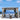 Outdoor gazebo with curtains overlooking a scenic ocean view.