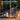 Solar yard outdoor lantern on a table with decorative items, set against a blurred patio background.