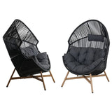 Black wicker egg chair with gray cushion, featuring a unique curved design and wooden legs for stability.