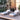 Outdoor patio furniture set with two lounge chairs and a small table on a wooden deck.