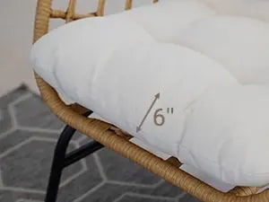 White cushion on a wicker chair with measurement text
