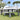 Grand Patio 13'x20' gazebo with double vent canopy and netting, featuring gray fabric and outdoor seating area.